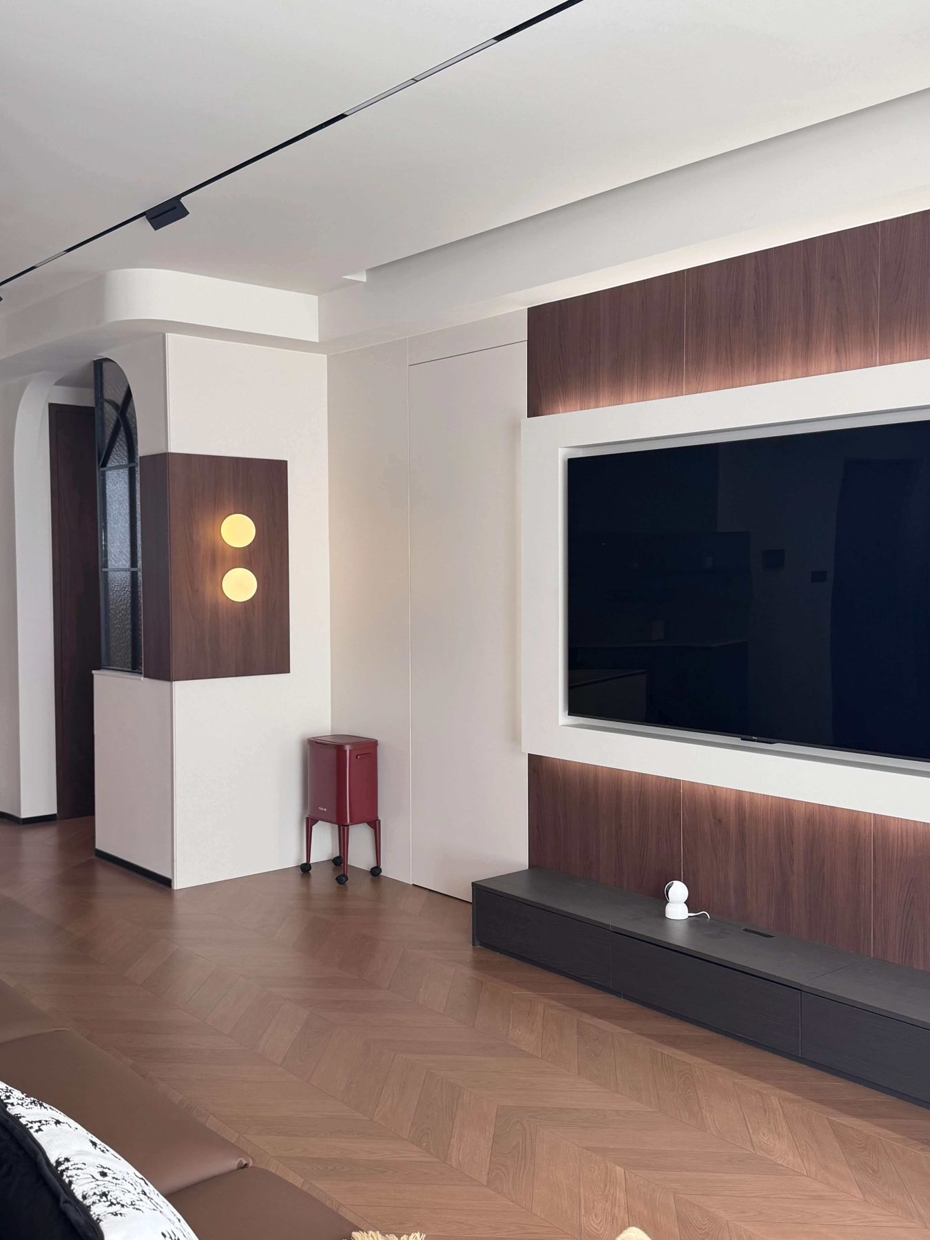 Low walnut media unit on the living room wall