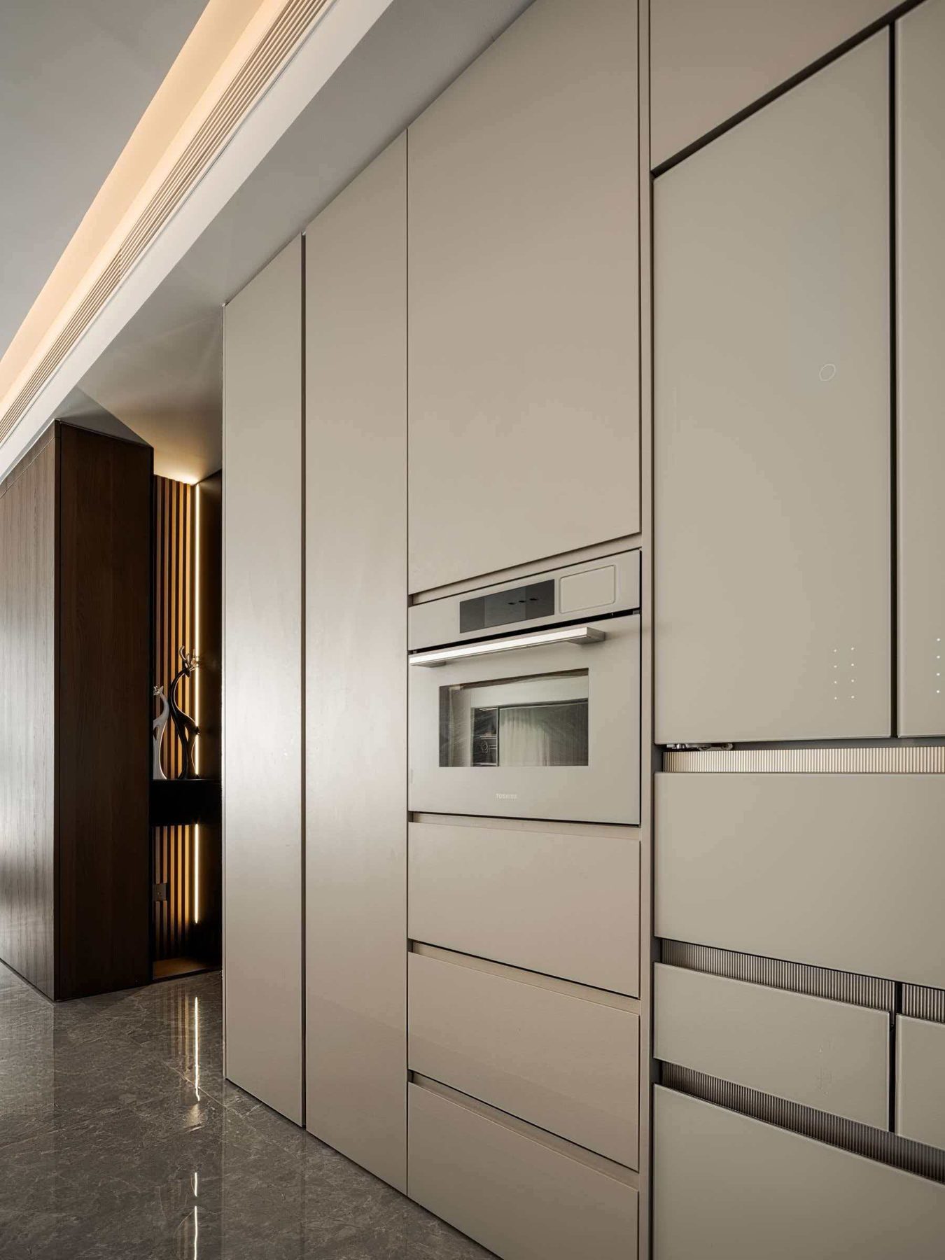 Full-height grey kitchen units with built-in oven