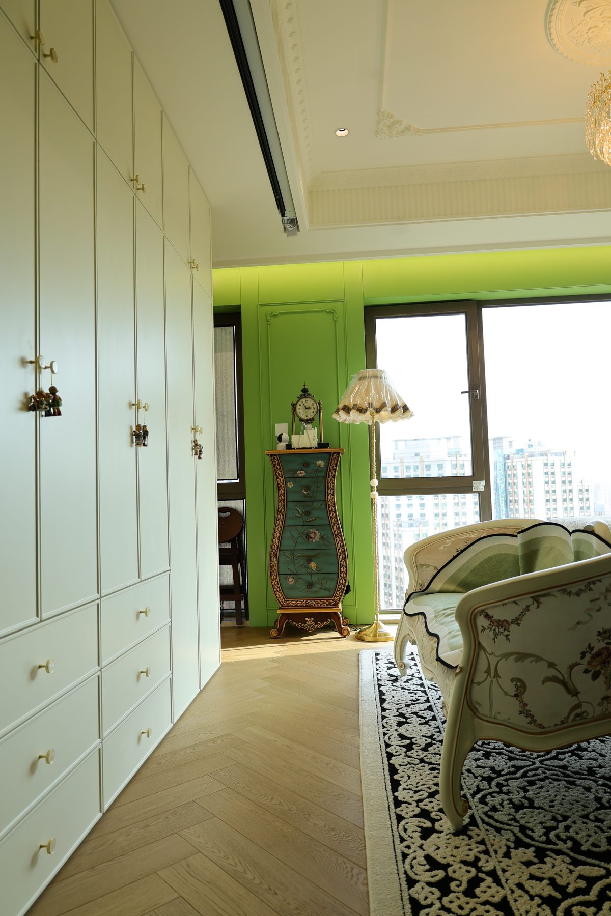 Wall of cream wardrobes next to a green panelled wall