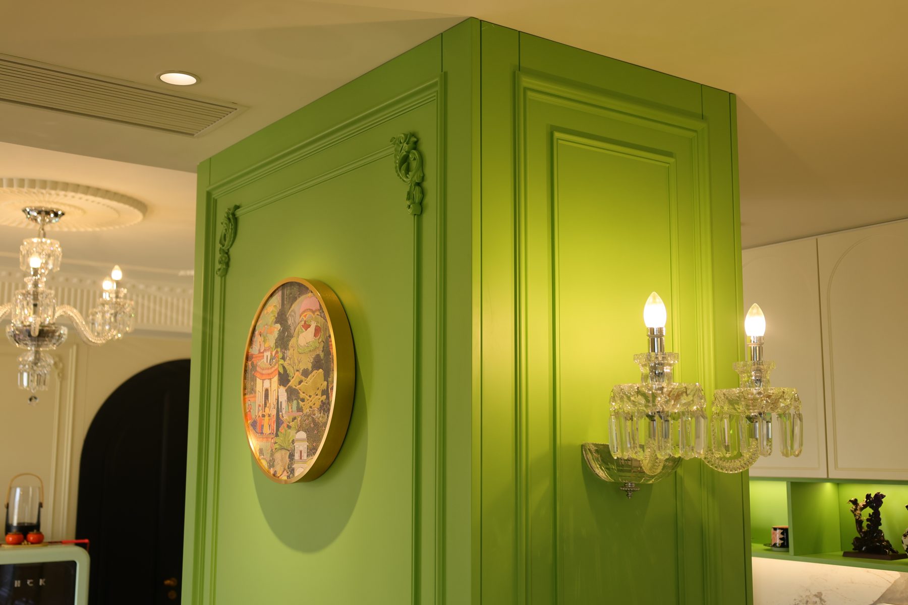 Column wrapped in green lacquered panelling with mouldings