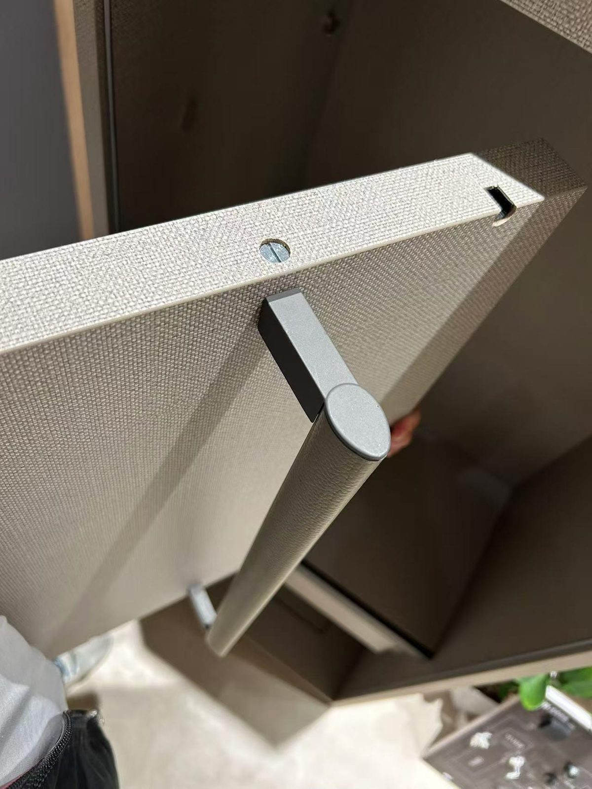 Leather-wrapped hanging rail mounted from the side of the shelf
